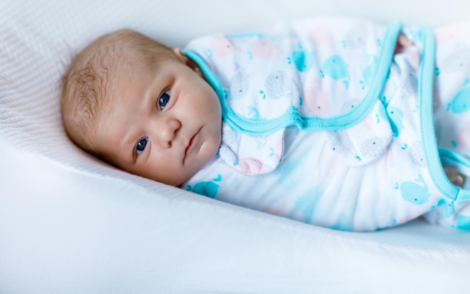 Parent using patting technique to settle baby to sleep
