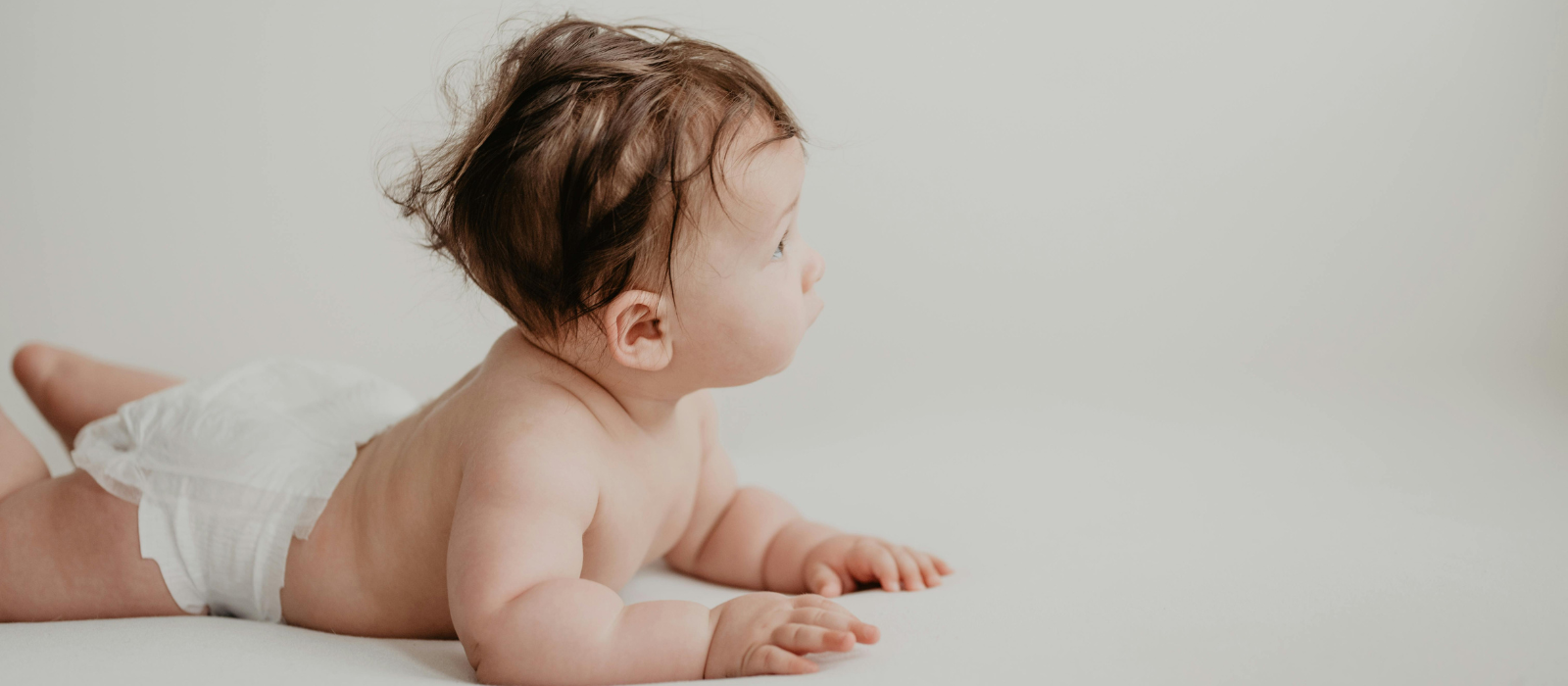 8 month old baby lying on floor