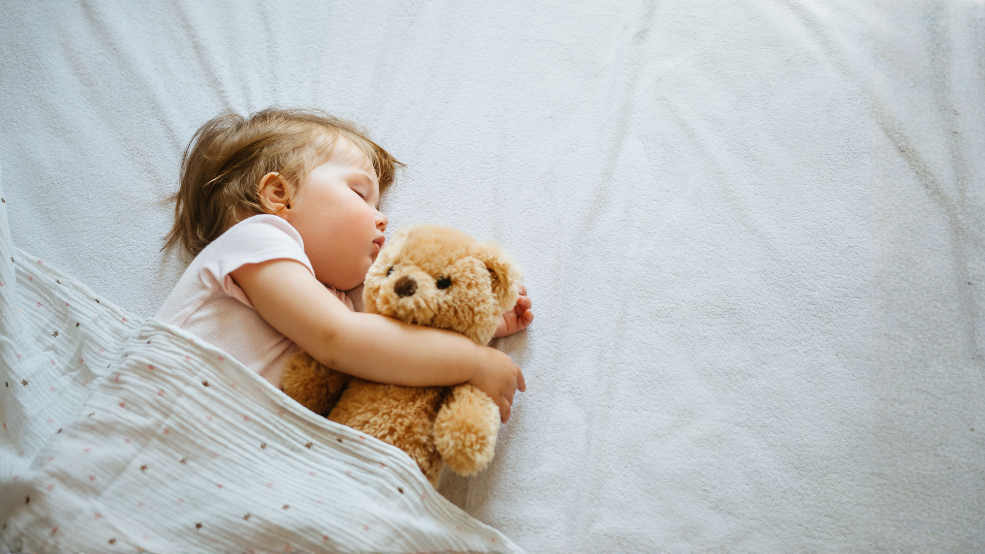 9 month old sleeping in bed